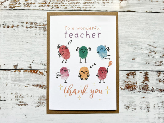 An A6 card with six fingerprinted birds on the front. The card reads 'To a wonderful teacher, thank you'.