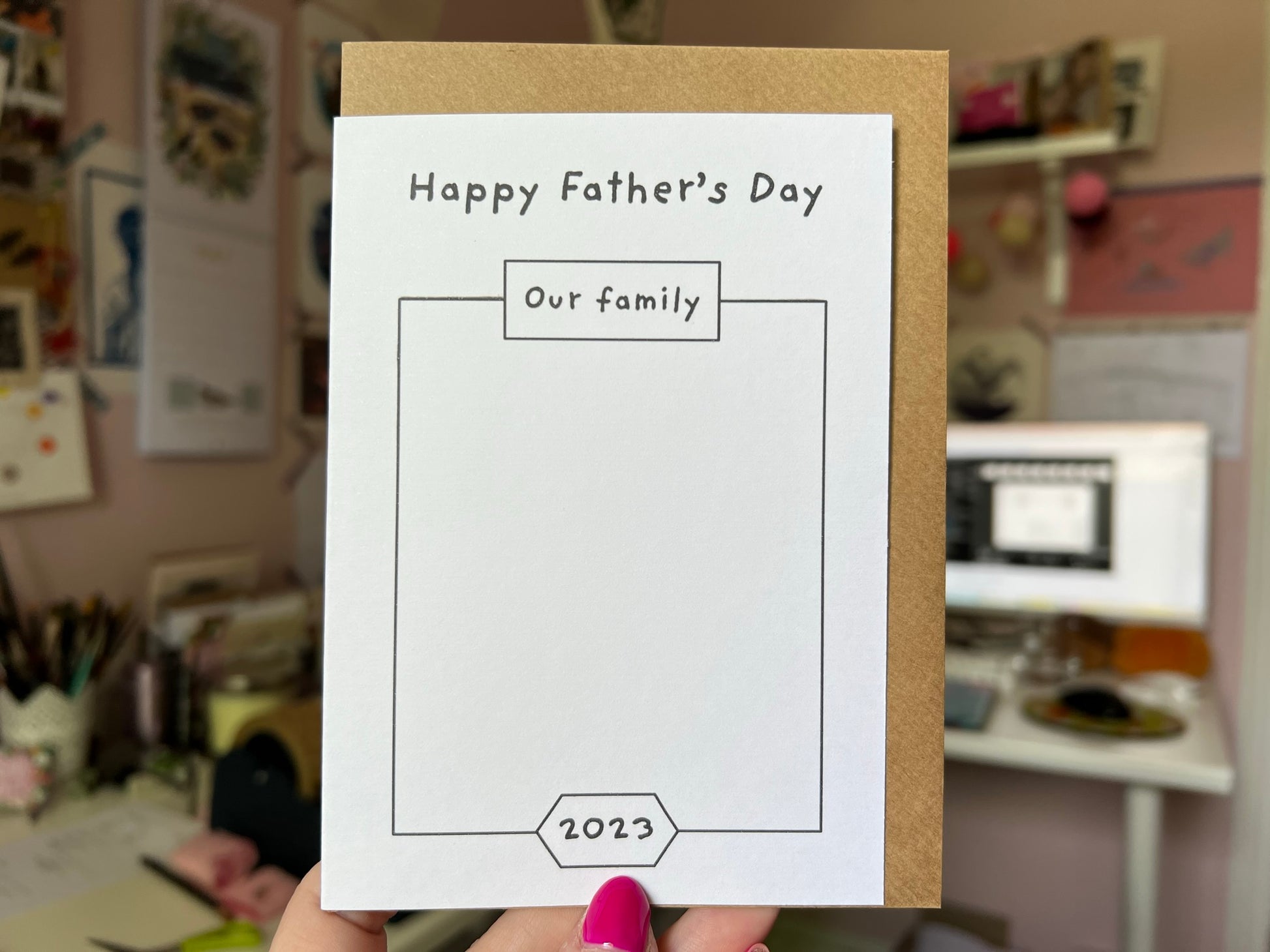 An A6 card saying 'Happy Father's Day' on the front and a big square on it for a child to draw a picture of the family
