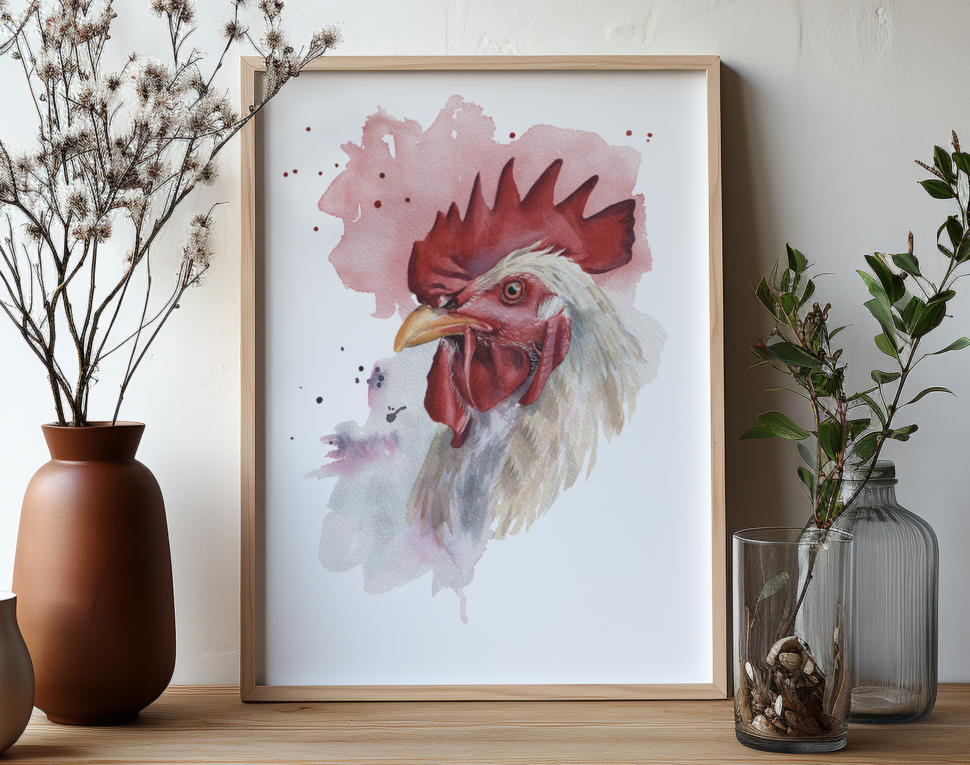 A watercolour print of a rooster in a mocked up frame