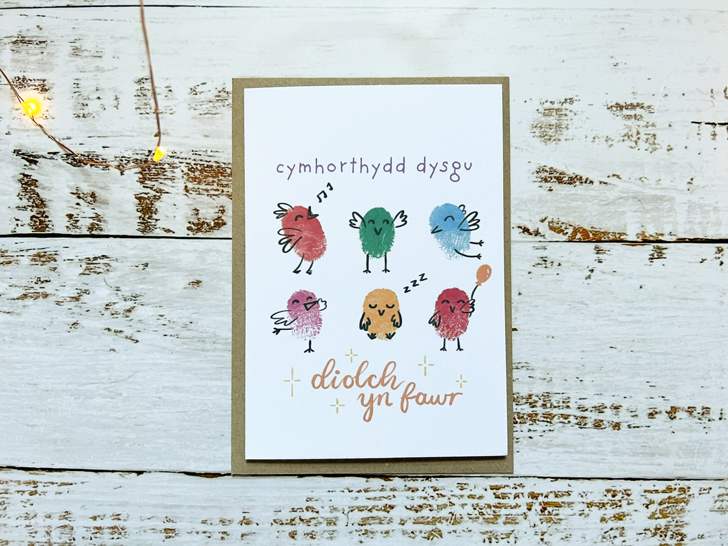 An A6 white card with six fingerprinted and illustrated birds on. The card reads 'cymhorthydd dysgu diolch yn fawr' (thank you teaching assistant in Welsh).