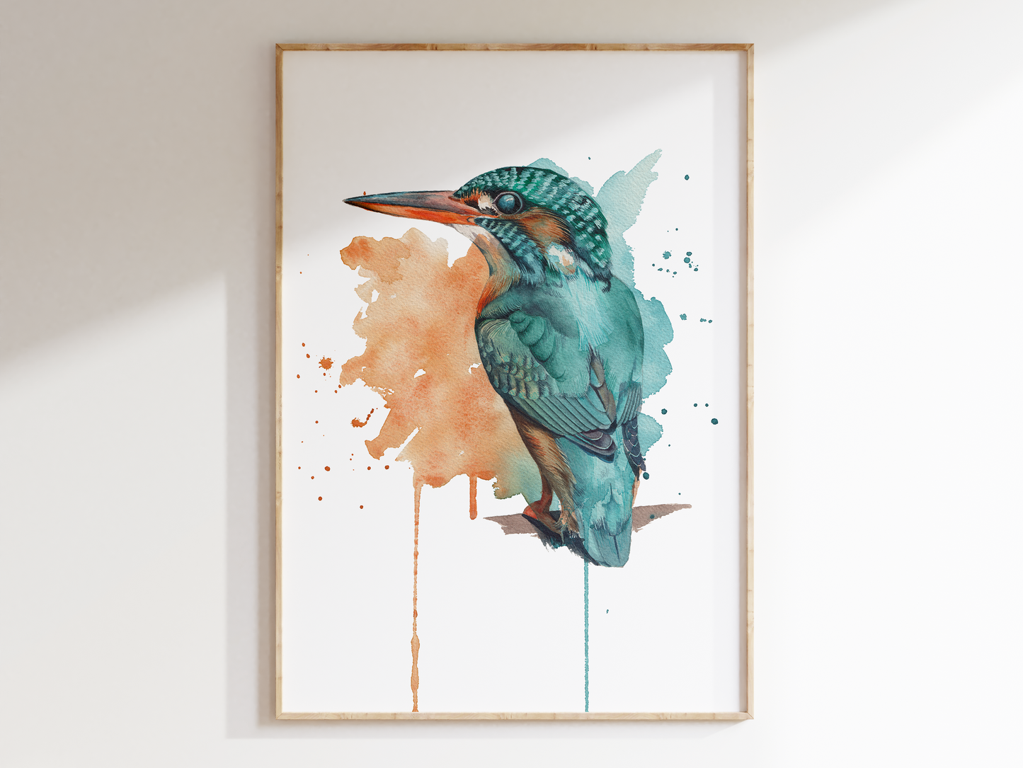 A photograph of a print of a watercolour kingfisher. It's painted in an expressive way, with splashes of watercolours and drips in the background, the background being made of the colours of the kingfisher. The kingfisher is painted in a detailed way, emerging from the background.