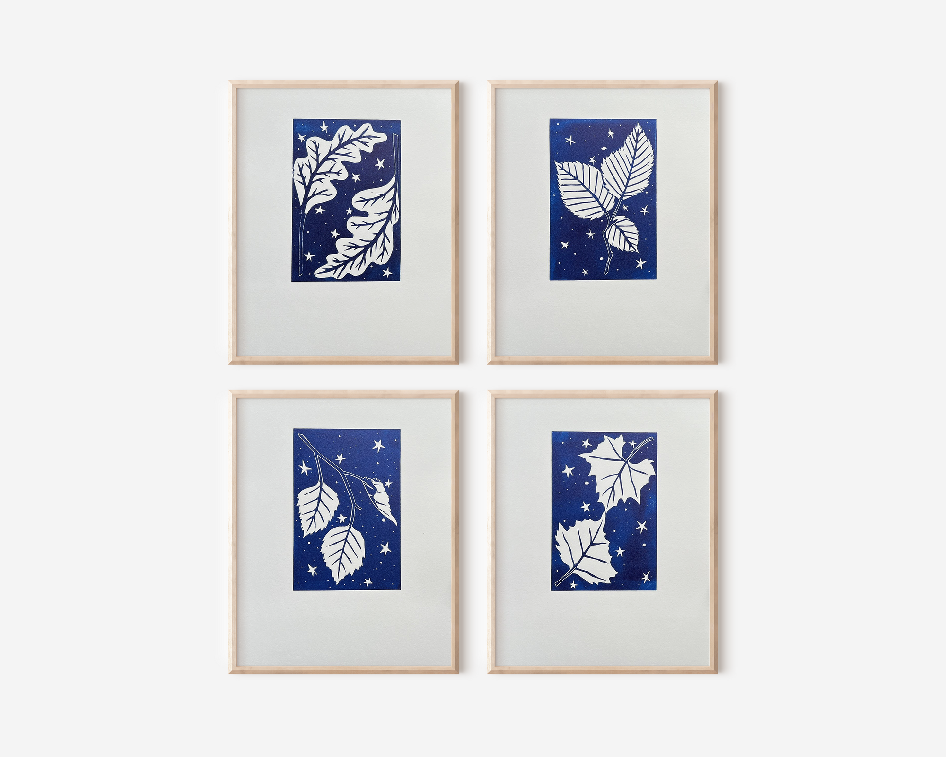 A mockup of all four prints framed on a white wall