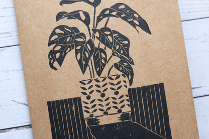 A lino printed sketchbook with a monkey monstera print on the front