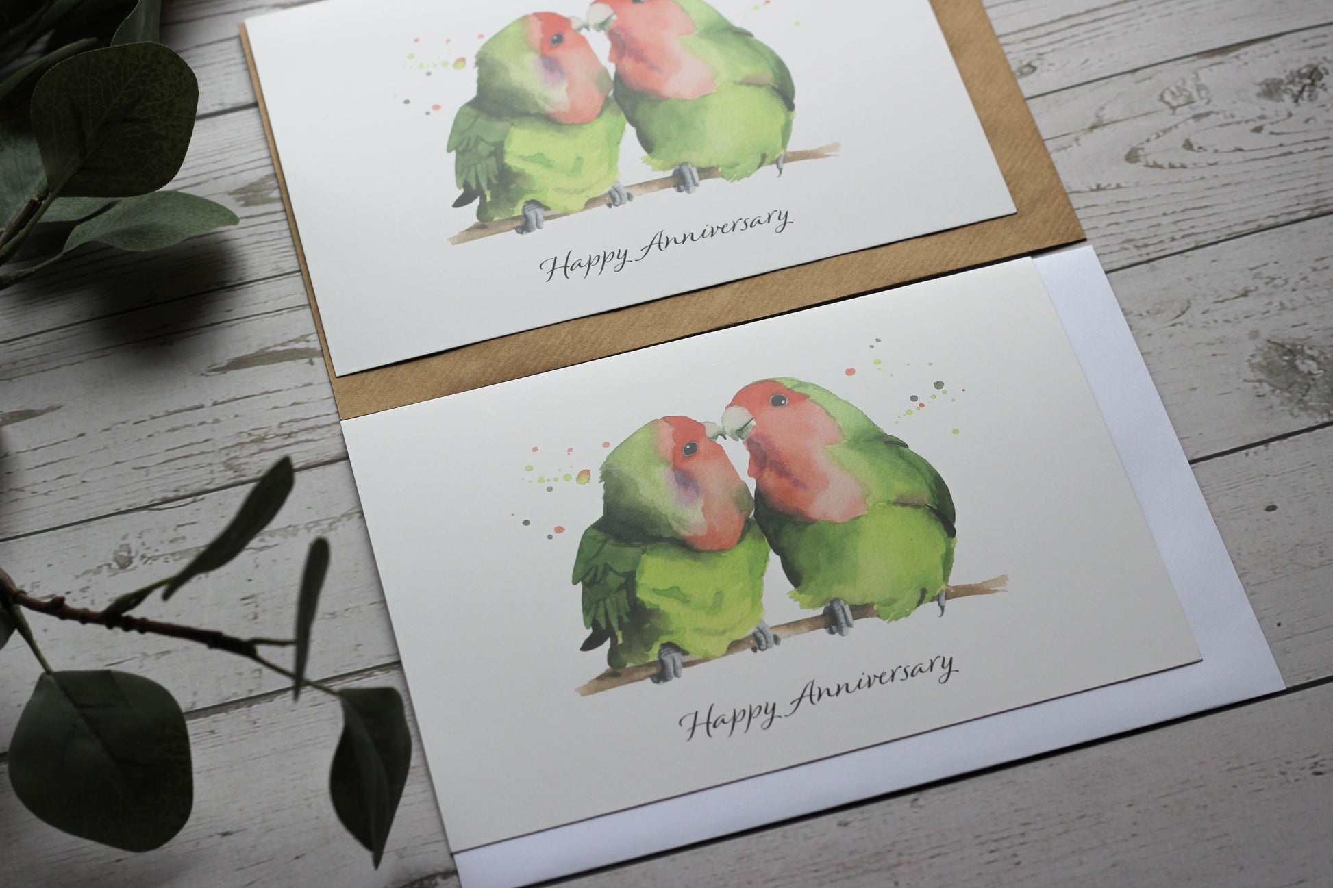 An A5 card of a watercolour print of two lovebirds