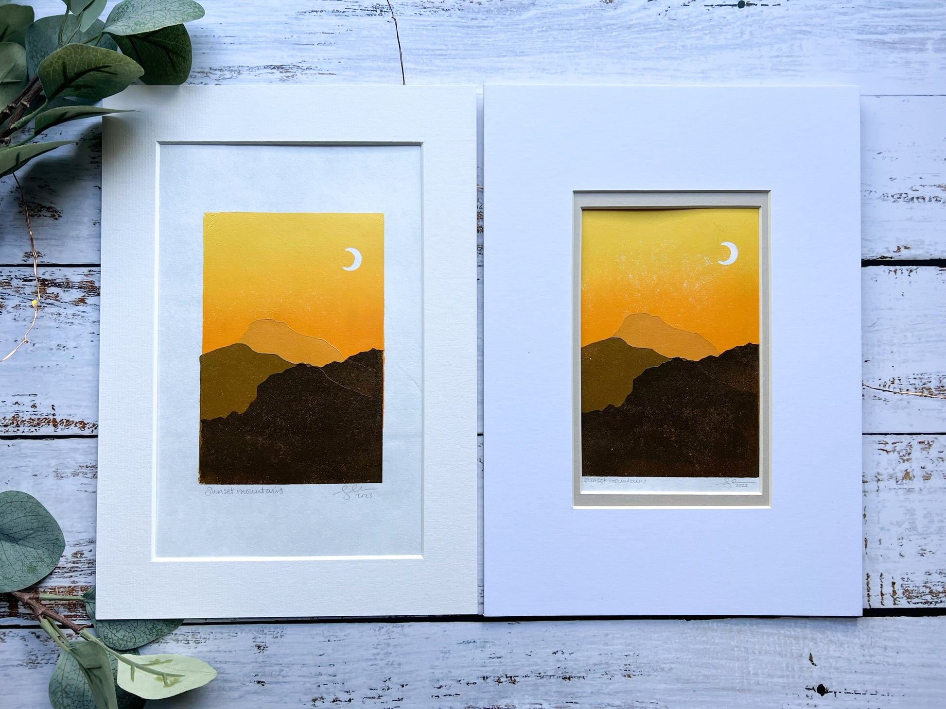 A multiblock lino print of mountains in the sunset, mounted.