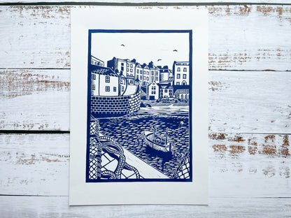 An A4 lino print of the iconic Tenby harbour in blue