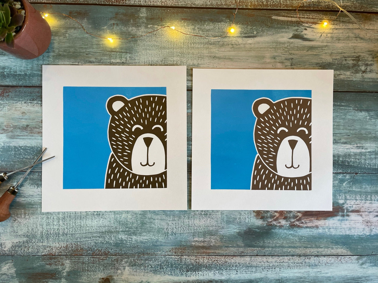 A multiblock lino print of a bear with a blue background