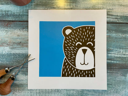 A multiblock lino print of a bear with a blue background