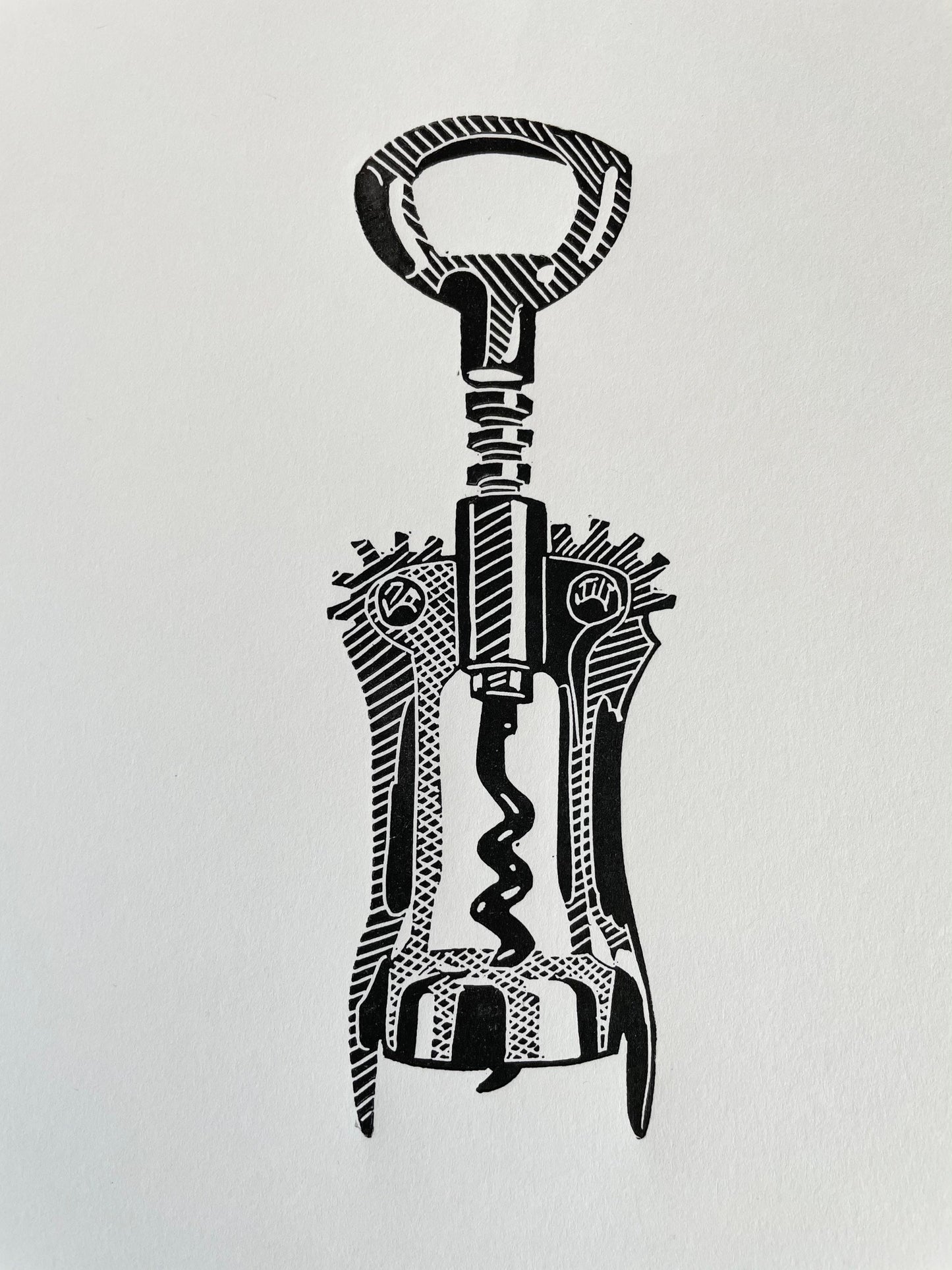 An A5 black lino print of a corkscrew bottle opener