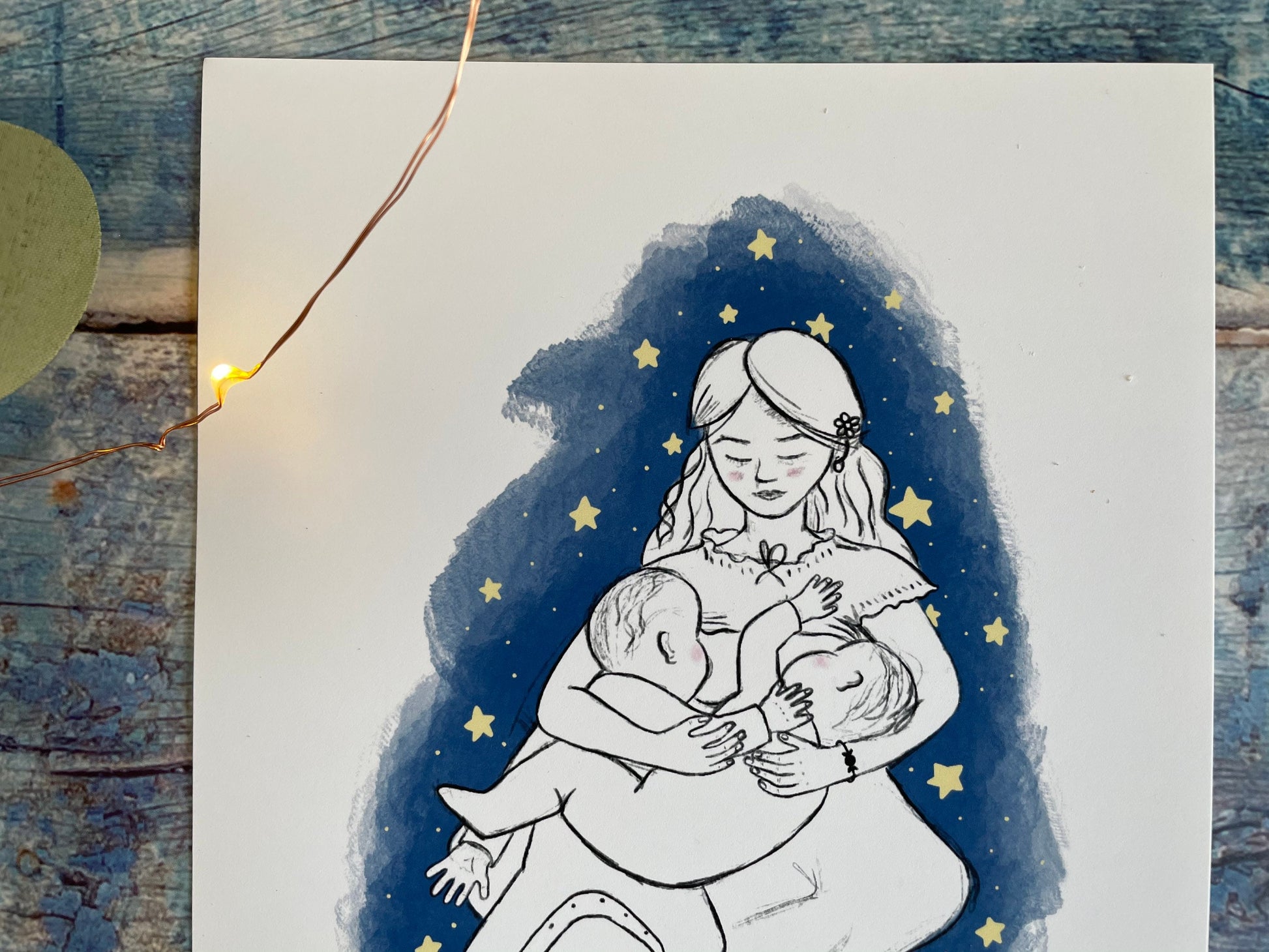 A close up of a digital sketch of a mother tandem breastfeeding two bigger babies, she's on a dark blue background surrounded by stars.