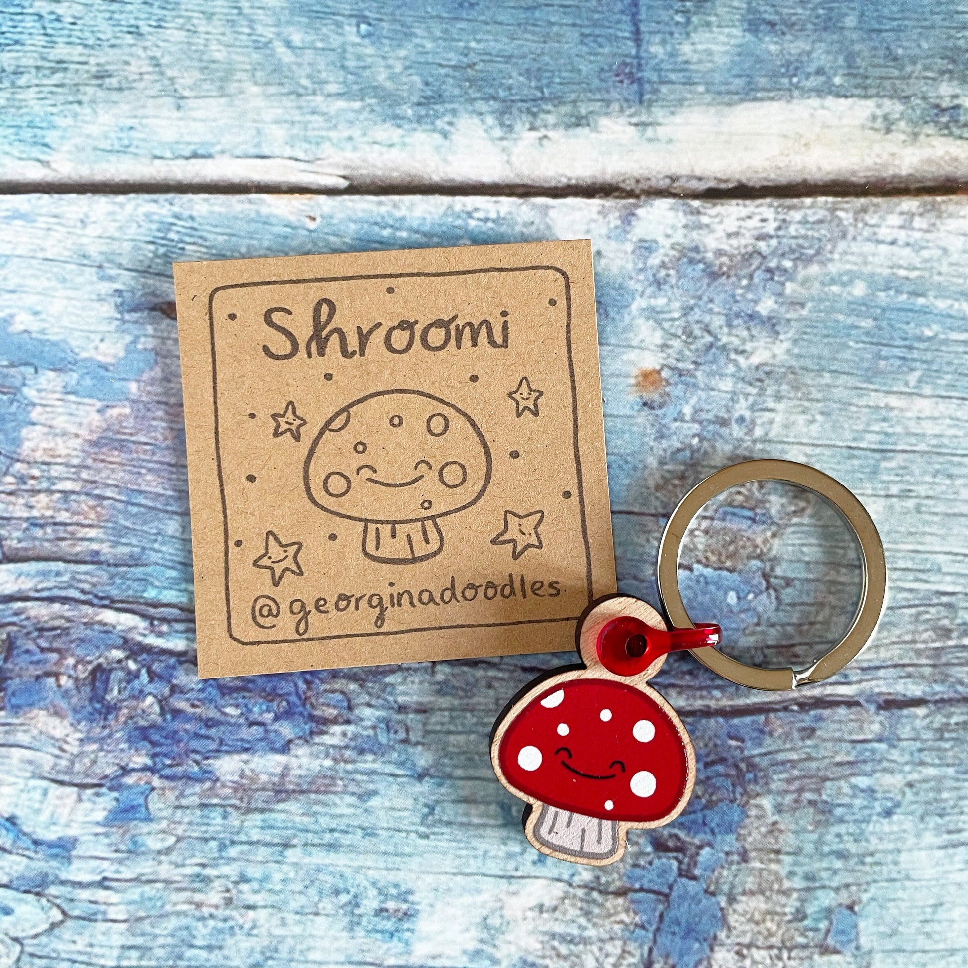 A cute 1 inch wooden mushroom keyring
