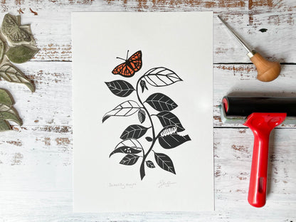 A lino print depicting the stages of a caterpillar turning into a butterfly while going up a vine