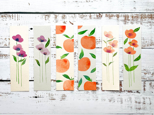 A photo of six hand painted watercolour bookmarks.