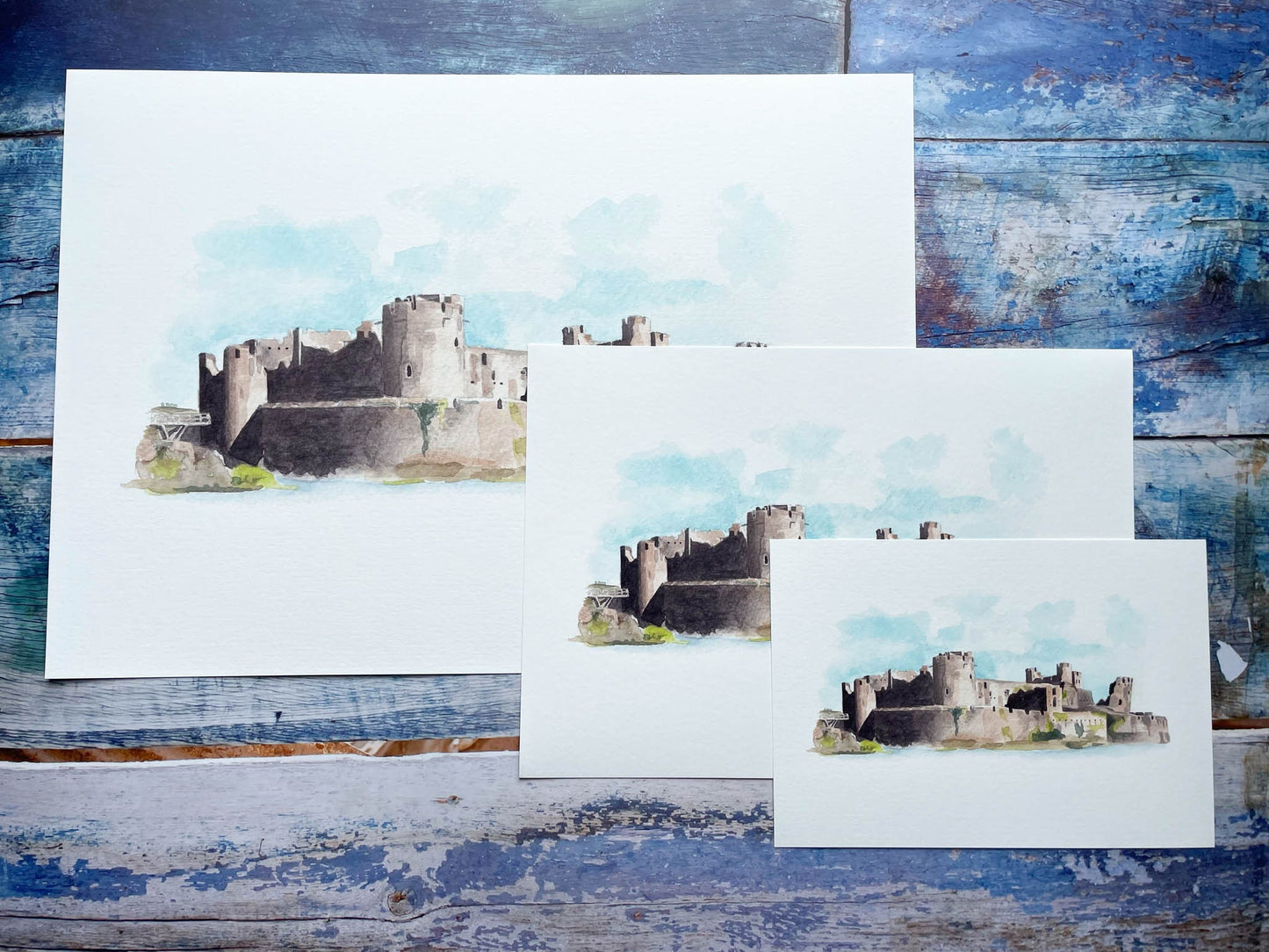 A watercolour print of Caerphilly castle with strong shadows in three different sizes (A3, A4, A5)
