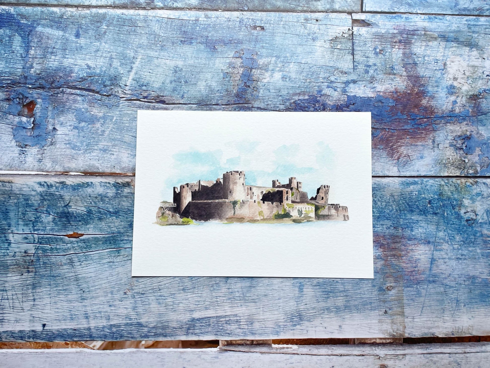 A watercolour print of Caerphilly castle with strong shadows