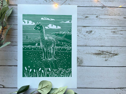 A green A4 lino print of a llama in a field