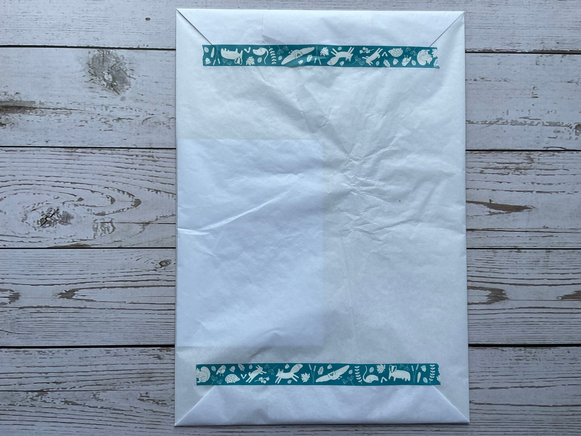 A print wrapped in tissue paper and stuck with washi tape