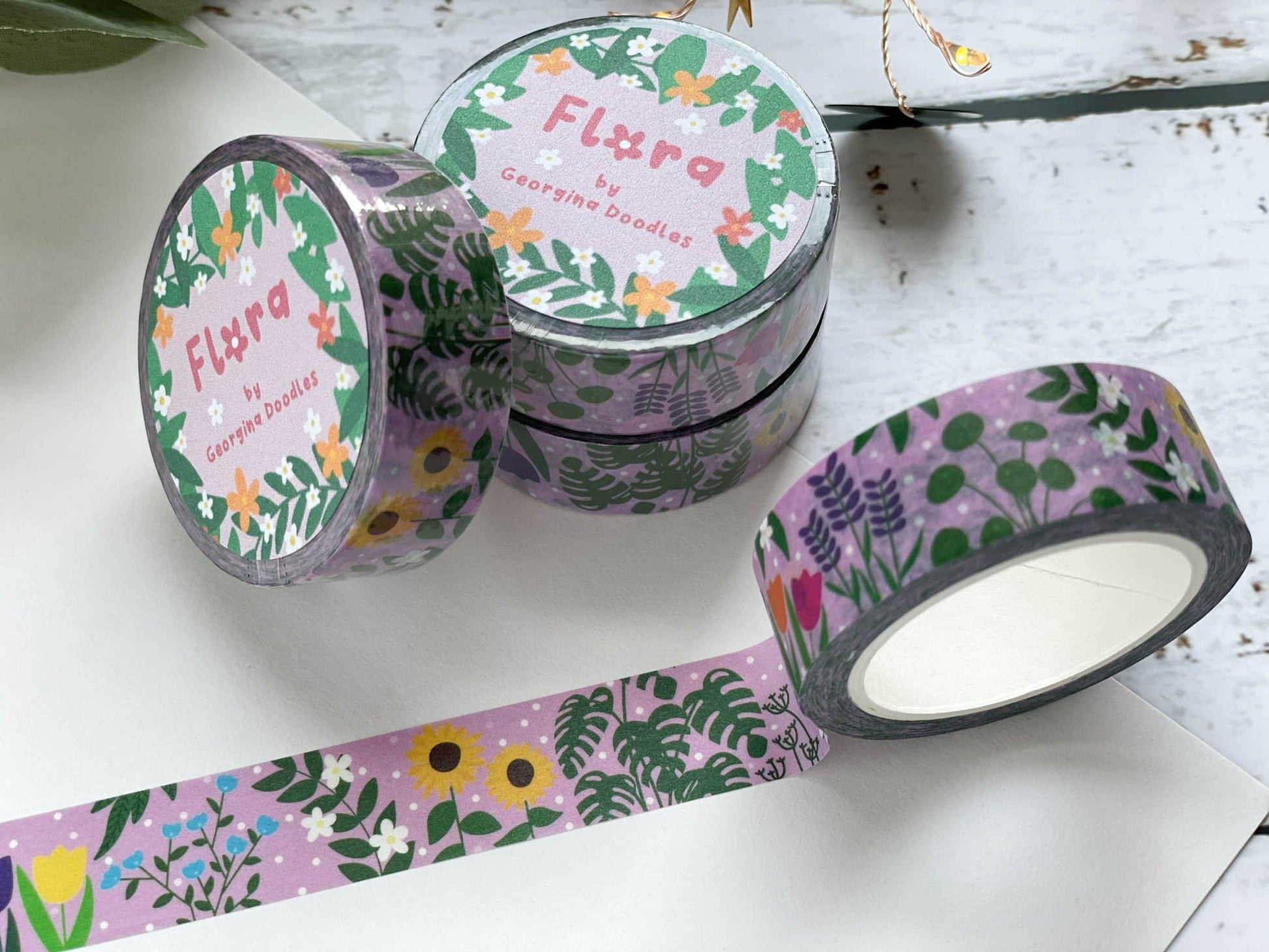 A close up of washi tape with a pink background and covered in flowers