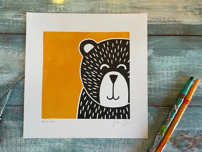 A multiblock lino print of a bear with a yellow background