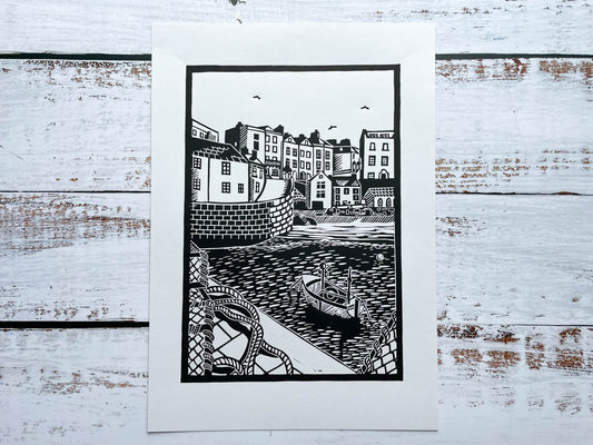An A4 lino print of the iconic Tenby harbour in black