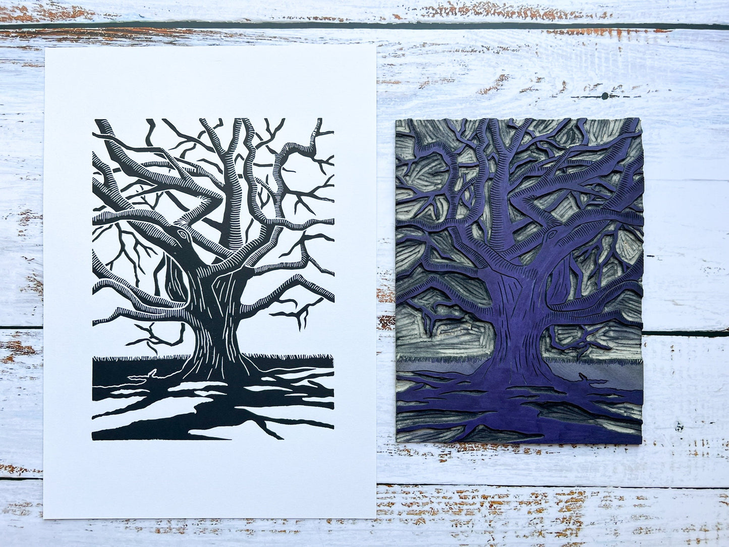 A lino print of a gnarly oak tree with dramatic shadows next to the carved lino block