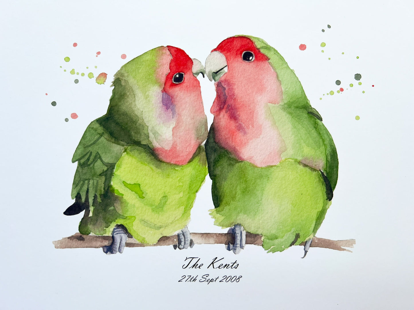 A watercolour print of two lovebirds, underneath is the surname of a couple and their date they got married