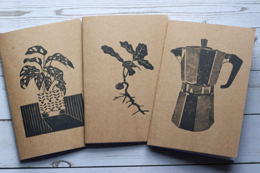 Three lino printed sketchbooks with kraft covers